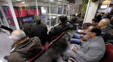 Iranian investors monitor an electronic board at the Tehran Stock Exchange